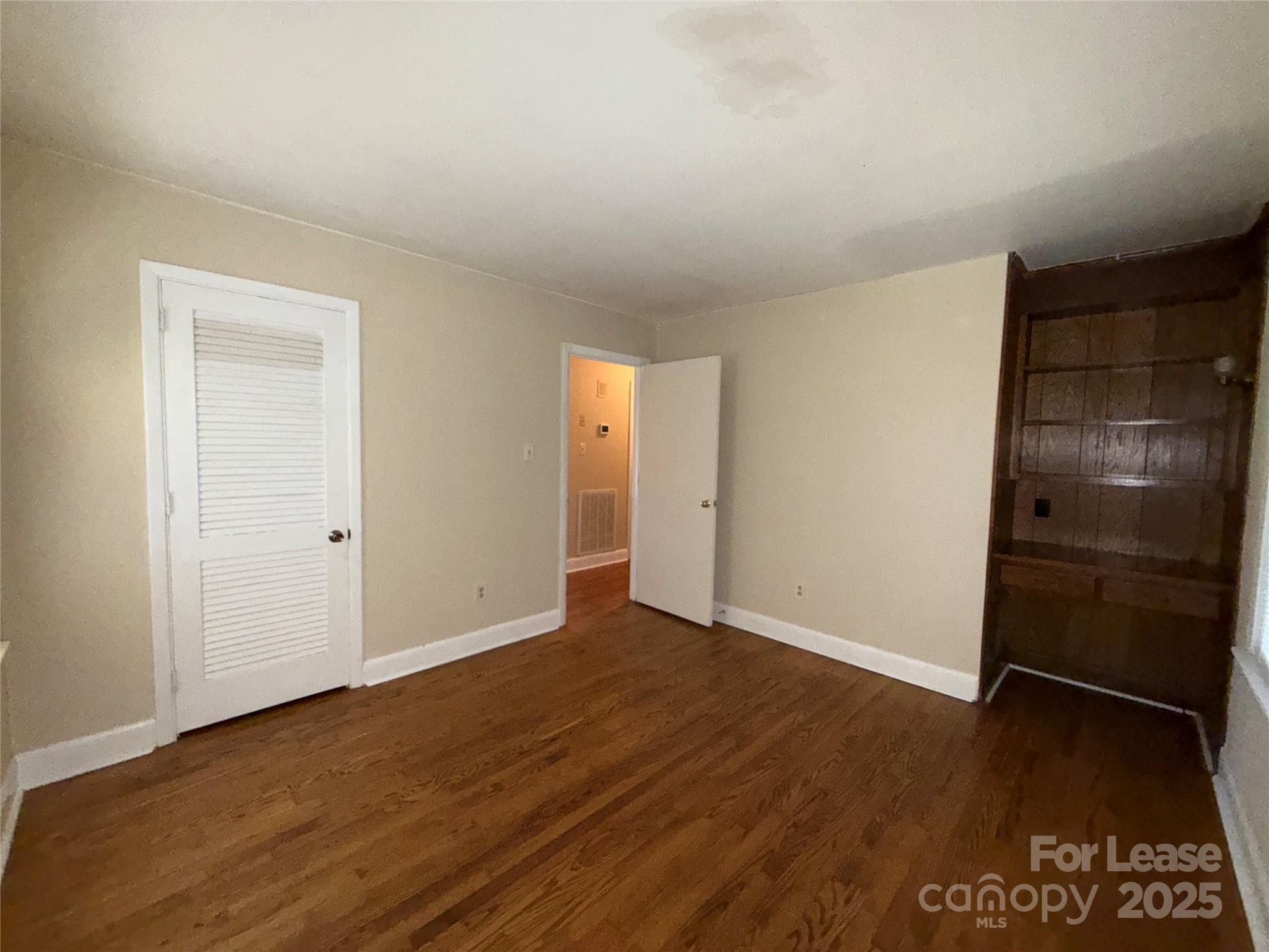 925 Perth Road Troutman, NC 28166 - Photo 19 of 31 a view of an empty room with wooden floor