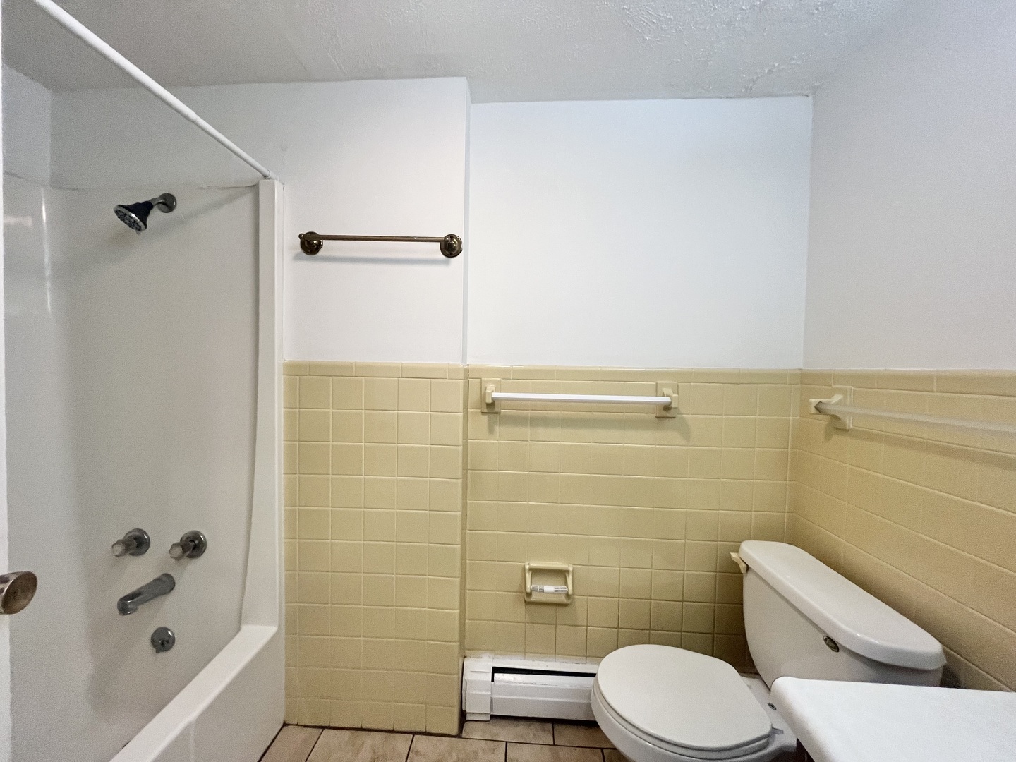 1006 Sheryl Lane Normal, IL 61761 - Photo 6 of 8 a white toilet sitting next to a bath tub and a shower