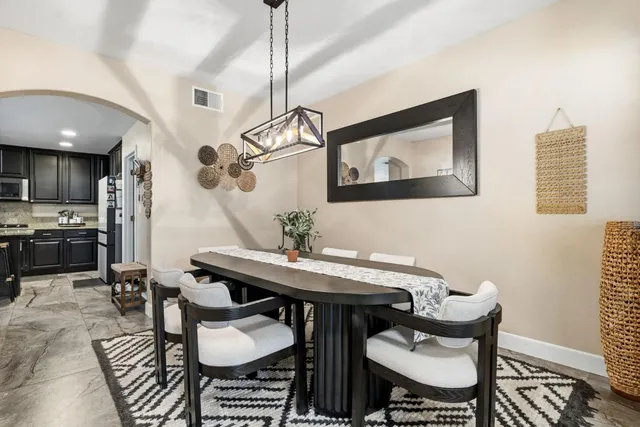 a view of a a dining room with furniture window and wooden floor