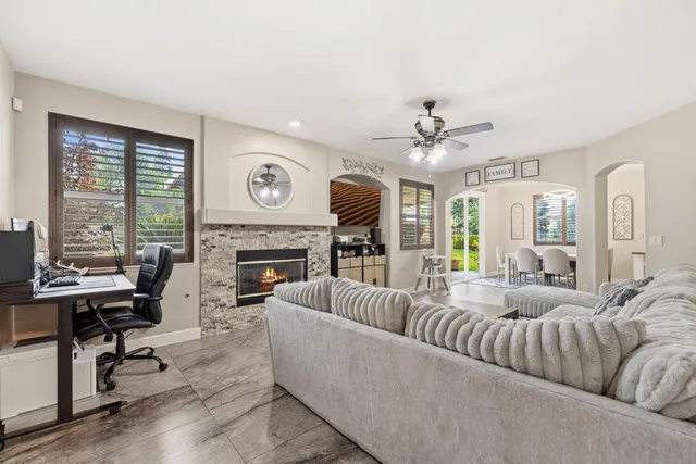a dining room with granite countertop a stove a sink a dining table and chairs