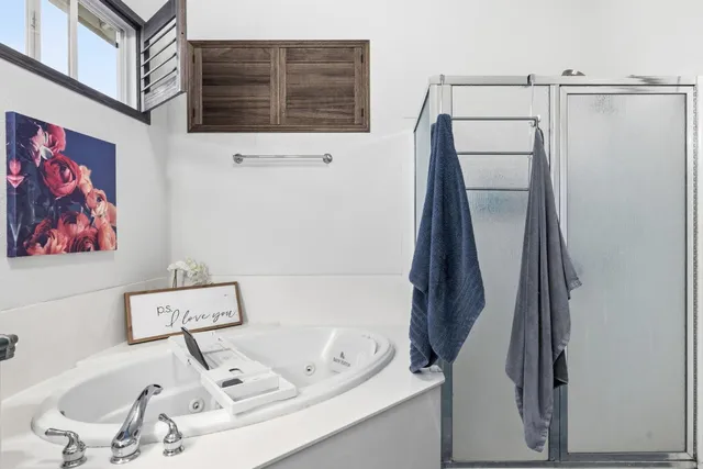 a bedroom with a bed dresser and a flat screen tv