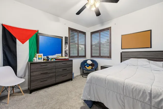 a bedroom with a bed and a tv
