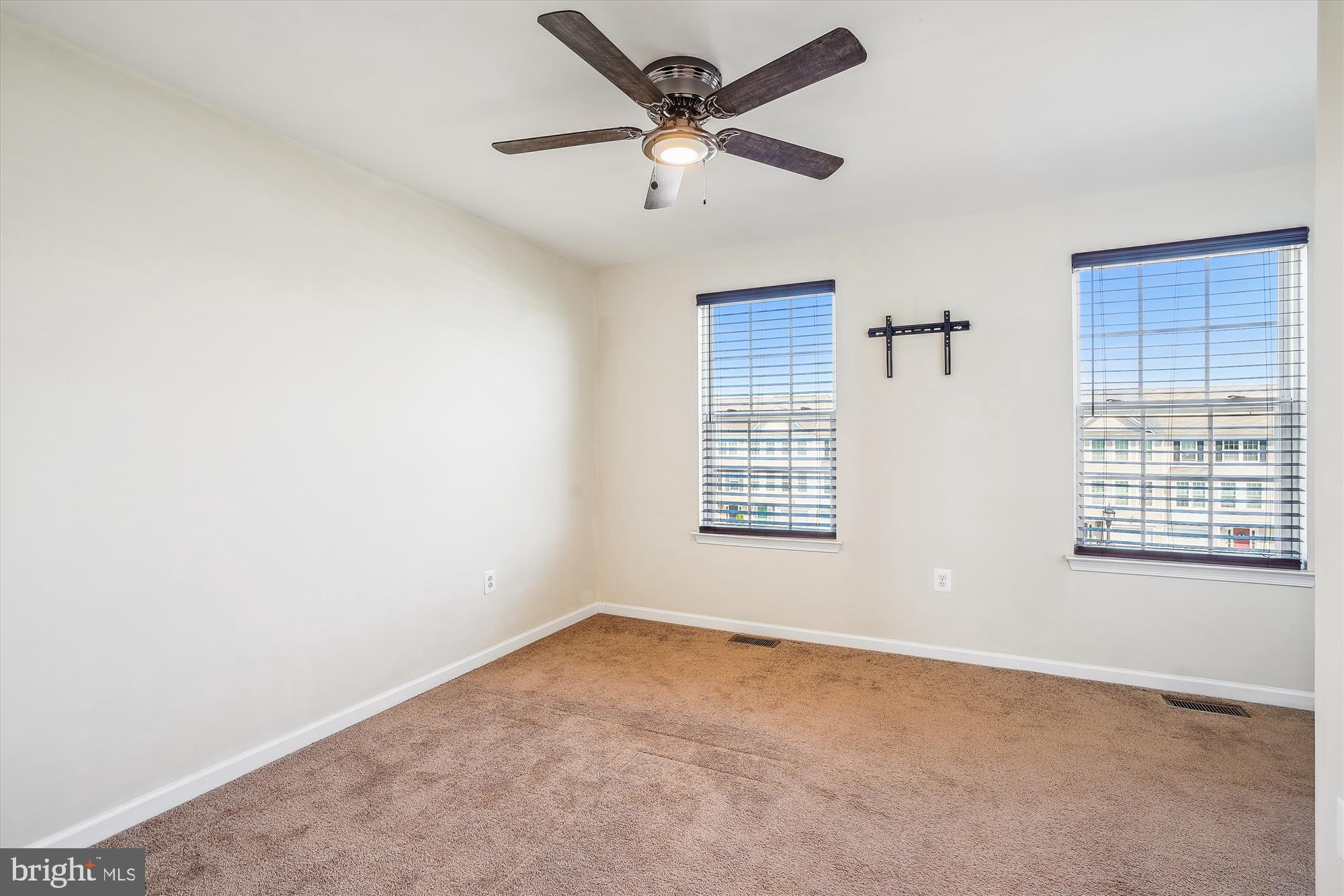 8359 Scotland Loop Manassas, VA 20109 - Photo 11 of 24 an empty room with a window and a ceiling fan