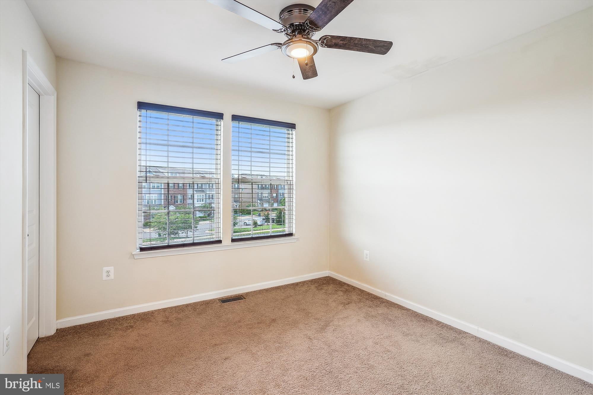 8359 Scotland Loop Manassas, VA 20109 - Photo 14 of 24 an empty room with a window and a fan