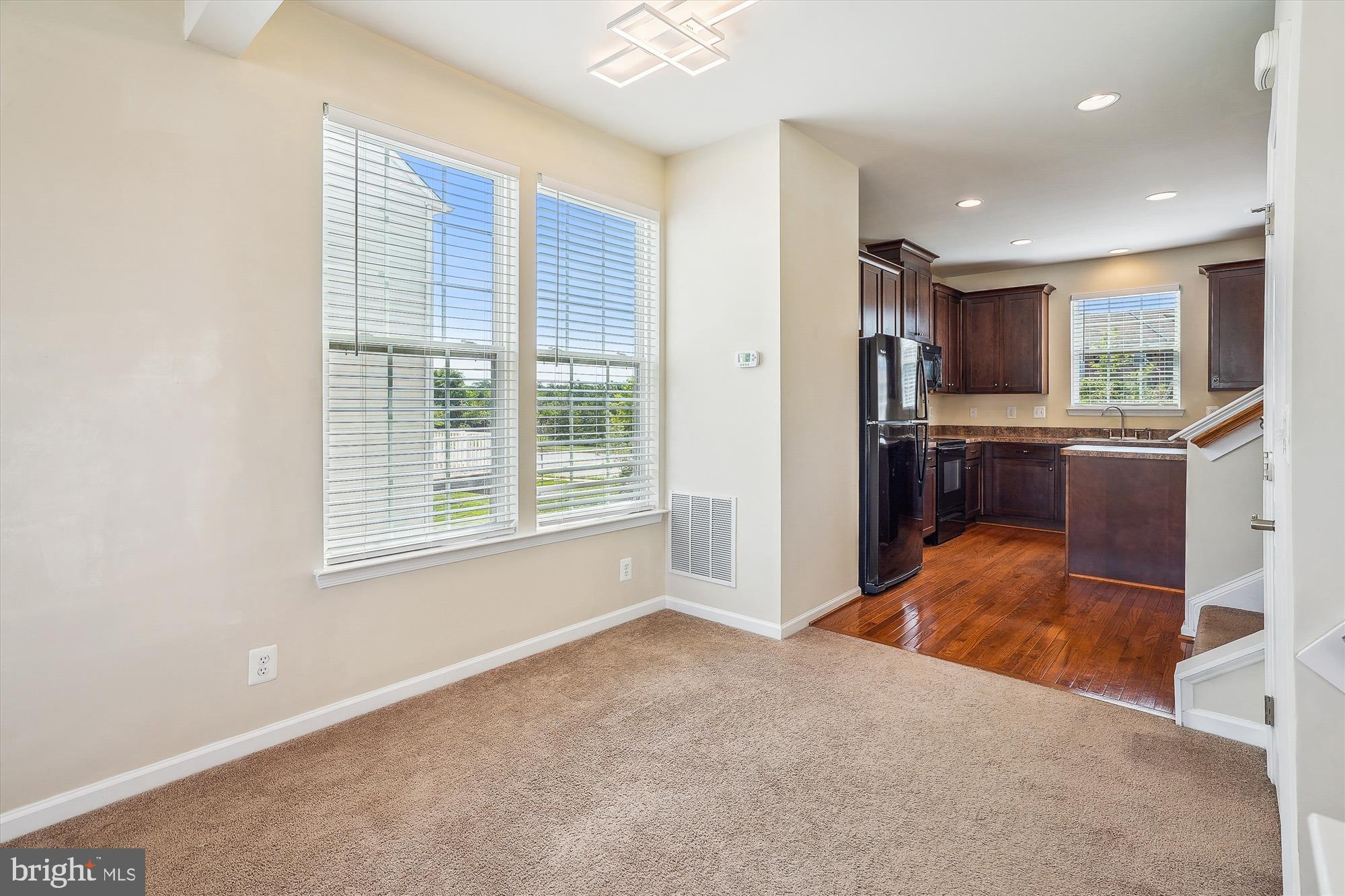 8359 Scotland Loop Manassas, VA 20109 - Photo 7 of 24 a view of a kitchen with kitchen island a sink wooden floor and a large window