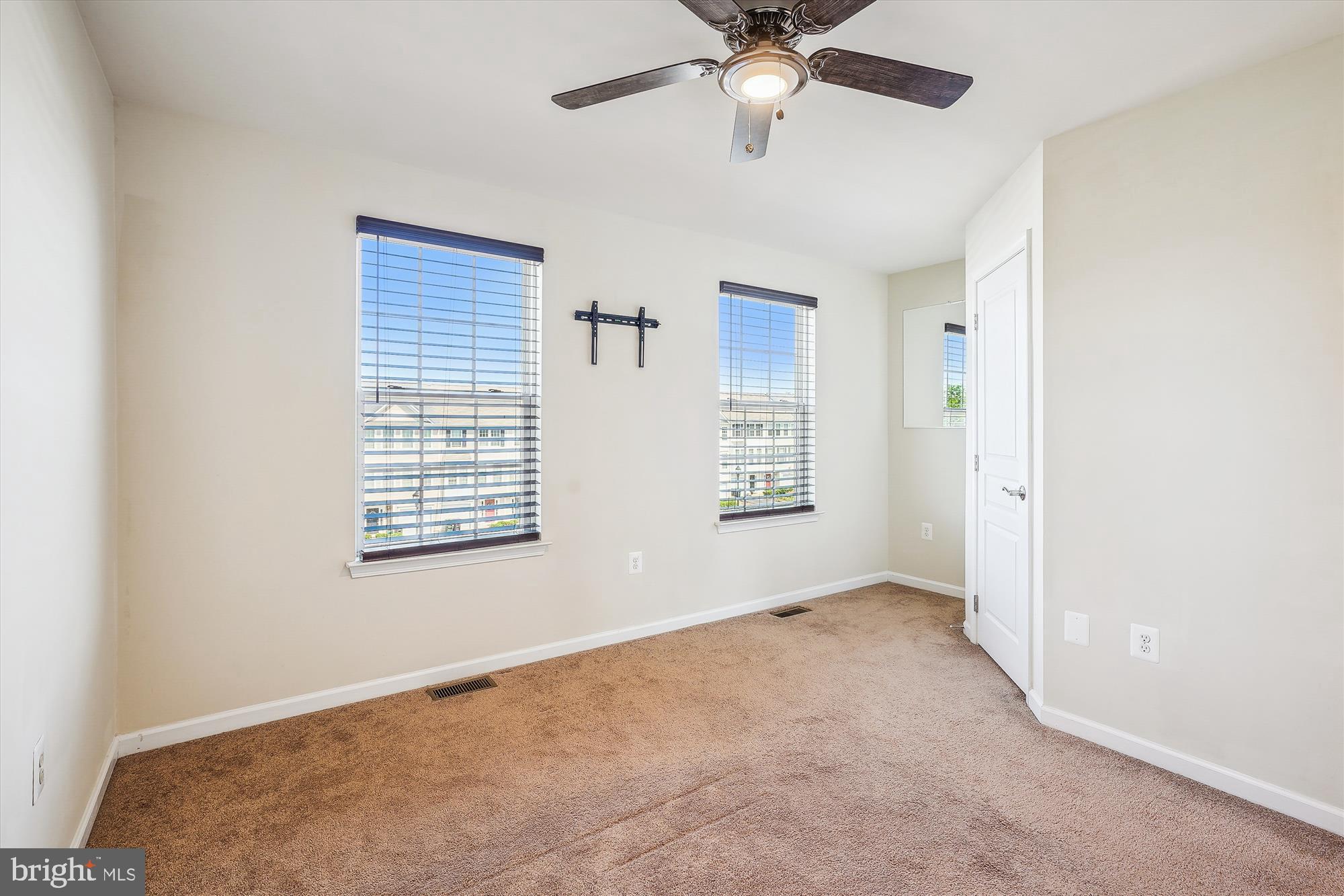 8359 Scotland Loop Manassas, VA 20109 - Photo 10 of 24 an empty room with windows and fan