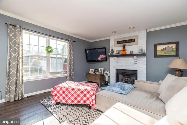 a living room with furniture fireplace and a flat screen tv