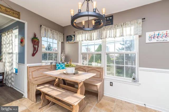 a living room with furniture a window and a chandelier