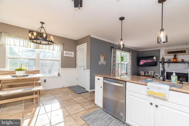 a kitchen with stainless steel appliances kitchen island granite countertop a sink and cabinets