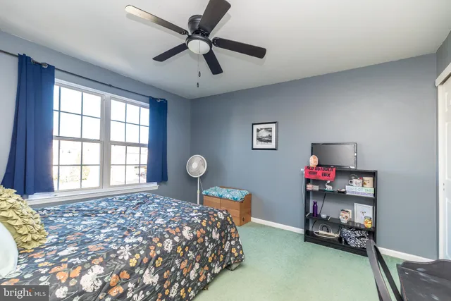 a bedroom with bed and a window