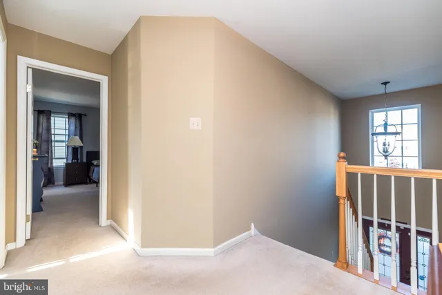 a view of entryway with wooden floor and a livingroom