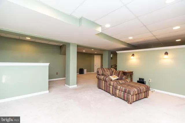 a living room with furniture and a projector screen