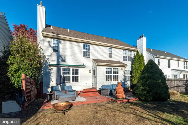 a view of a house with backyard sitting area and furniture