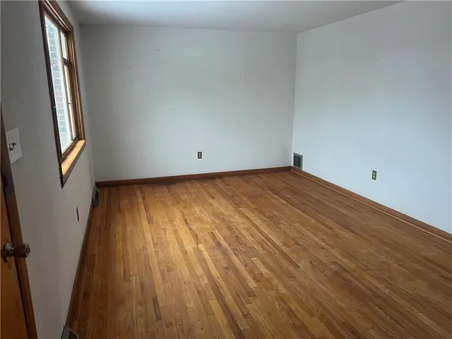 a view of a room with wooden floor and stairs