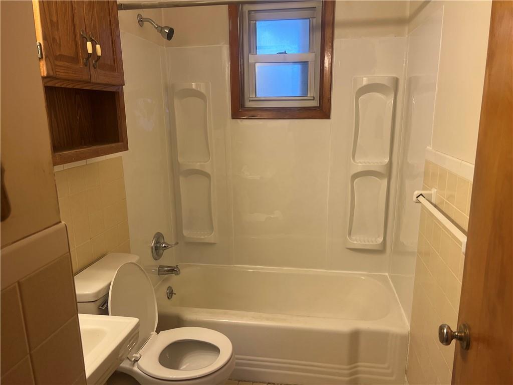 1020 Poe Street Vandergrift, PA 15690 - Photo 8 of 16 a bathroom with a sink toilet and shower