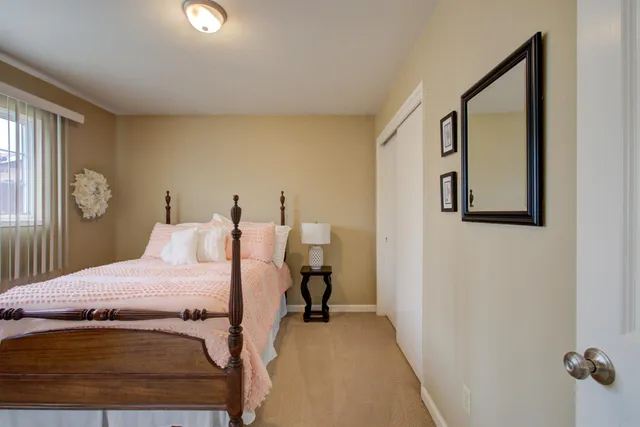 a bedroom with a bed and hallway