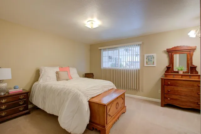 a bedroom with a bed and a dresser