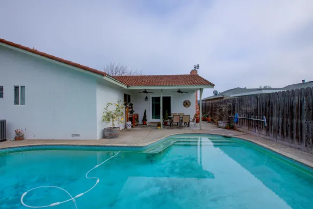 a view of a house with backyard porch and sitting area