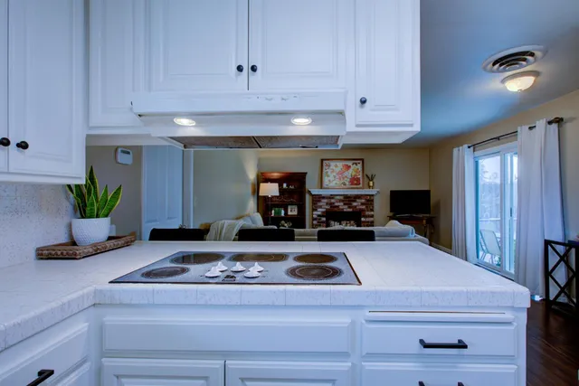 a view of kitchen island with a stove a refrigerator and a counter top