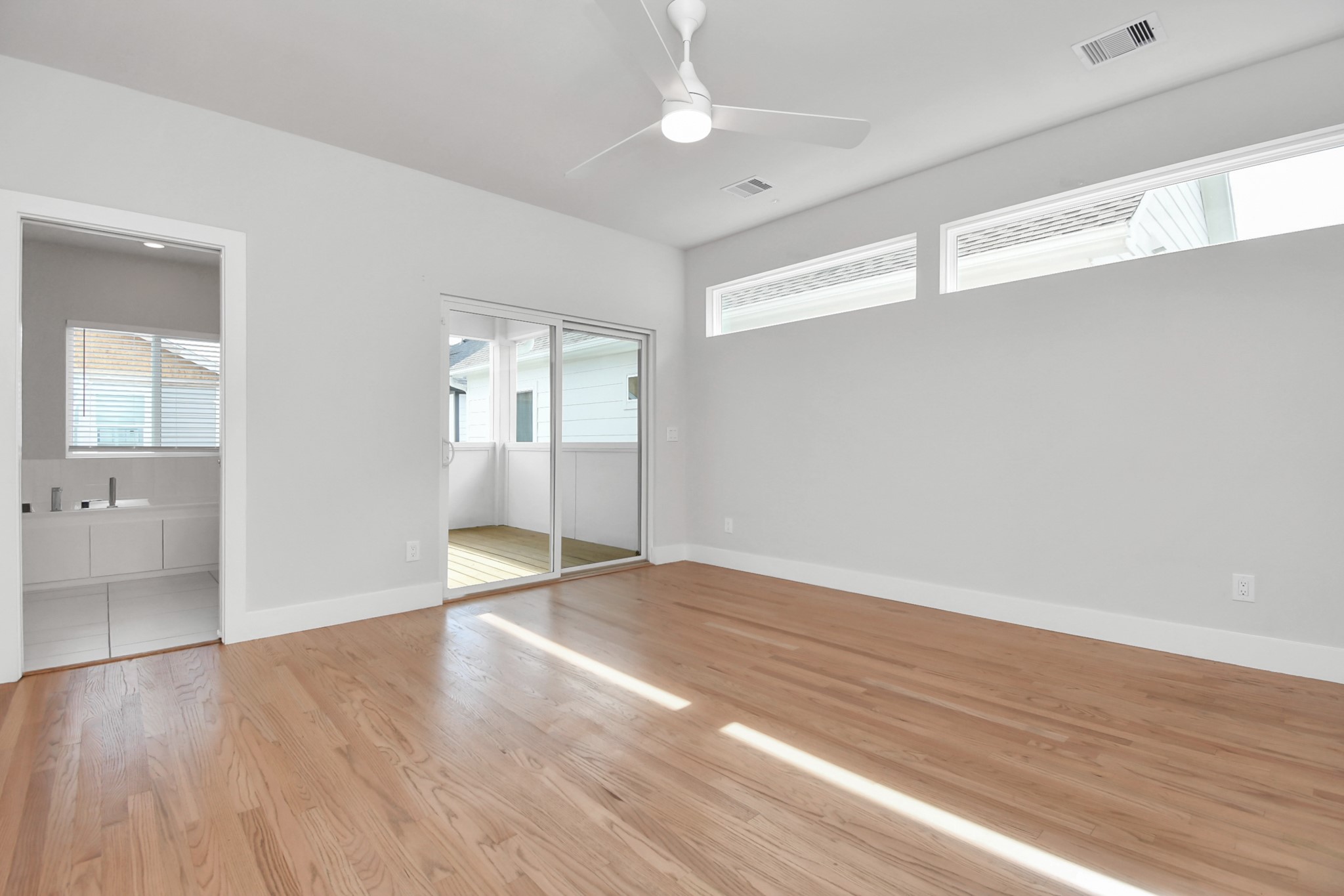 4709 Oats Street Houston, TX 77020 - Photo 14 of 34 wooden floor in an empty room with a window