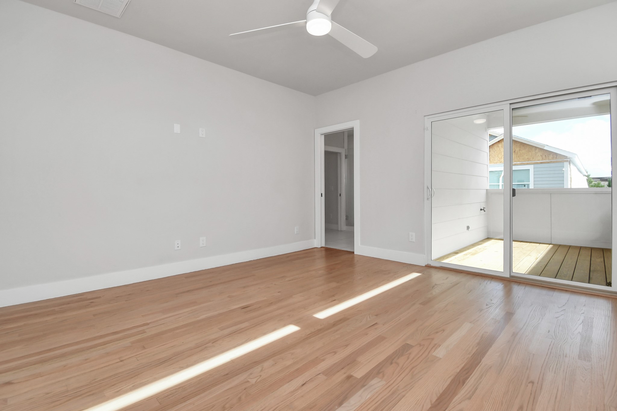 4709 Oats Street Houston, TX 77020 - Photo 15 of 34 wooden floor in an empty room with a window