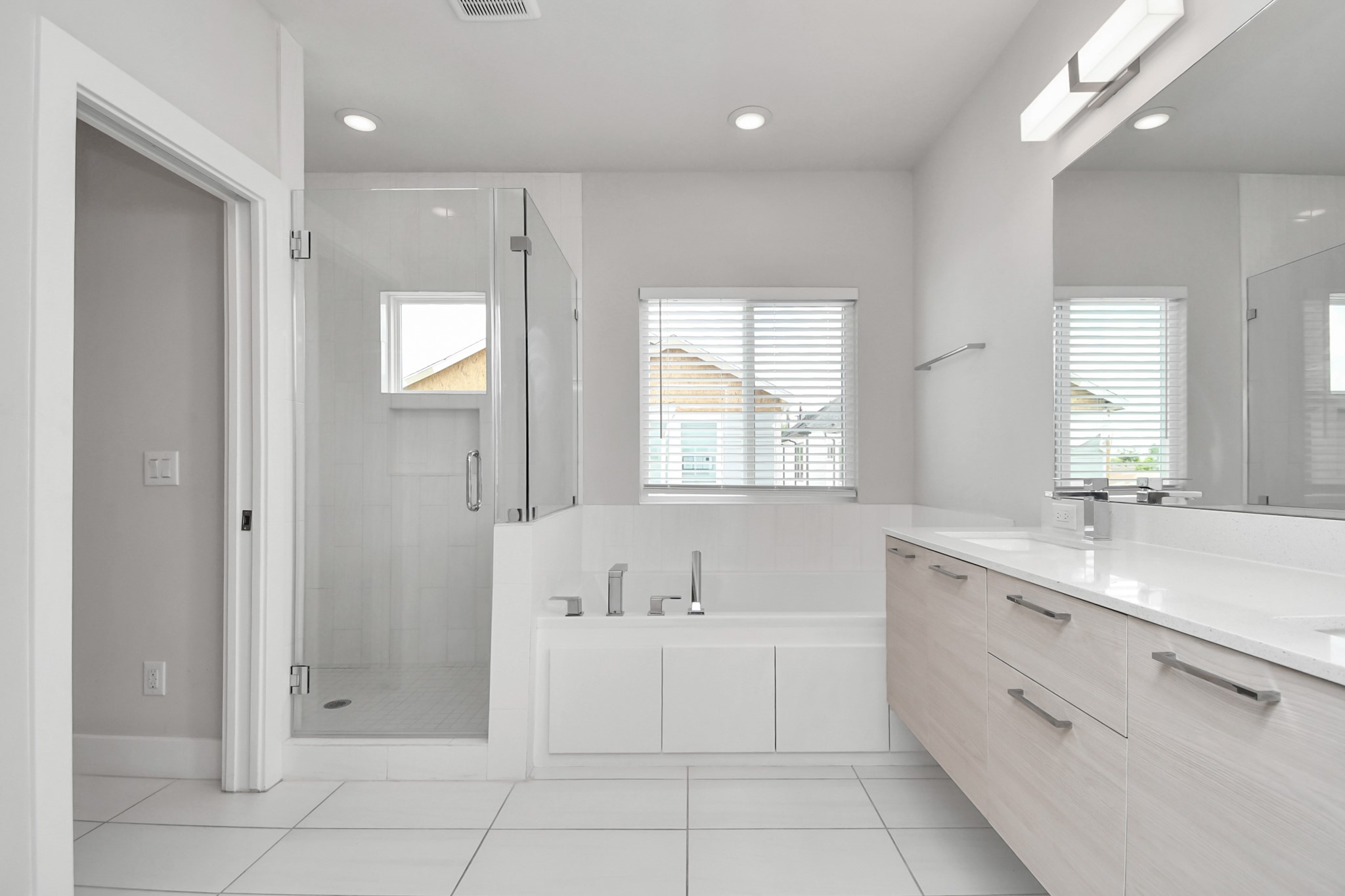 4709 Oats Street Houston, TX 77020 - Photo 18 of 34 a spacious bathroom with a double vanity sink a mirror and a bathtub