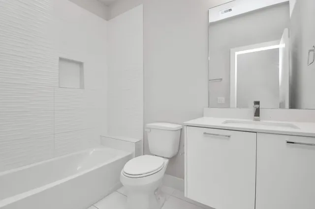 an empty room with wooden floor & closet and windows