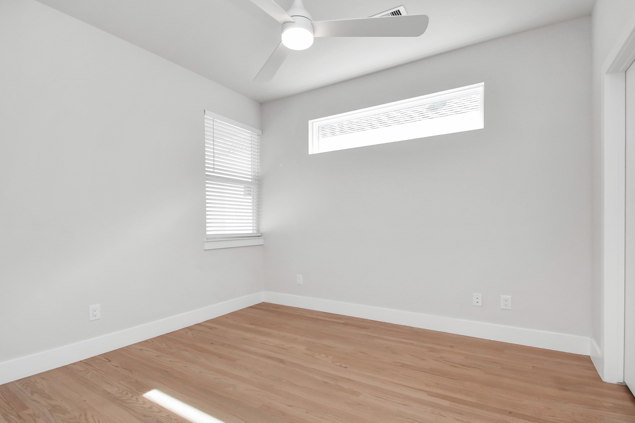4709 Oats Street Houston, TX 77020 - Photo 24 of 34 an empty room with wooden floor and windows