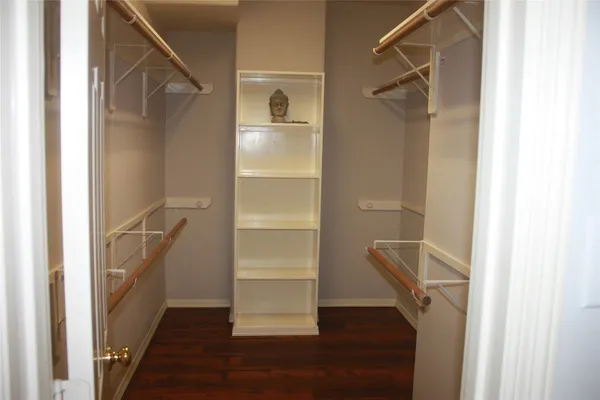 a view of walk in closet with empty racks