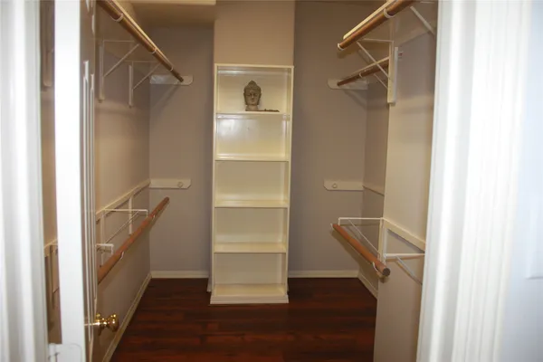 a view of walk in closet with empty racks
