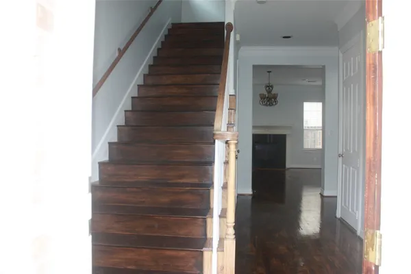 a view of entryway and hall with wooden floor