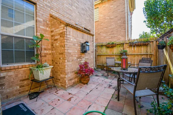 a backyard of a house with table and chairs