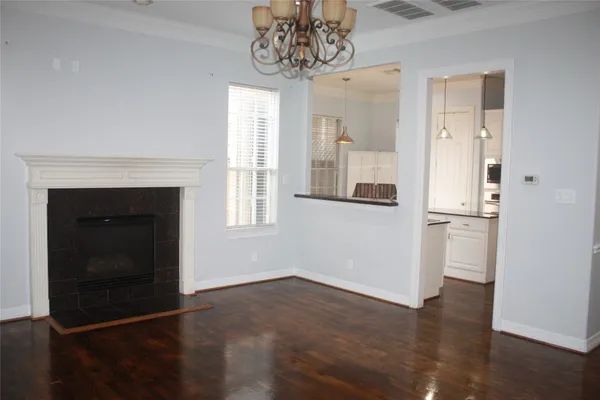 a view of a kitchen with a fireplace and wooden floor