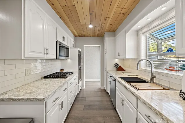 a kitchen with stainless steel appliances a refrigerator sink and cabinets