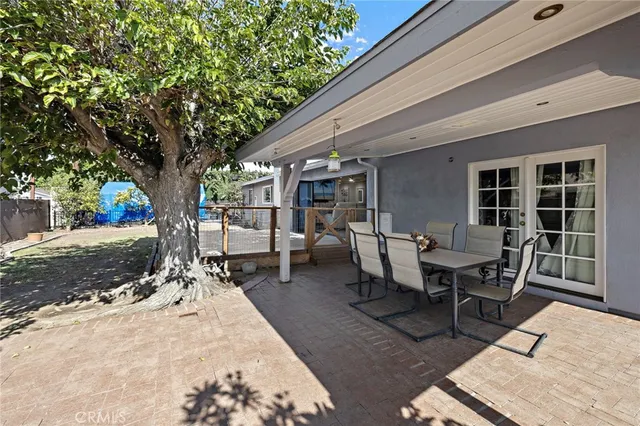 a dining room with furniture and a floor to ceiling window