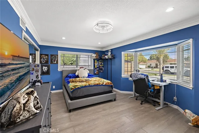 a bedroom with a large bed and a chandelier