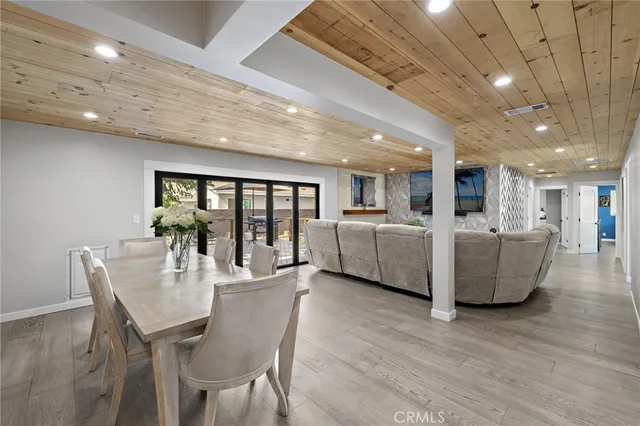 a dining room with furniture and wooden floor