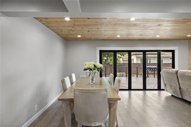 a dining room with furniture and wooden floor