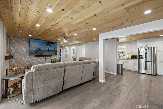 a living room with furniture and kitchen view