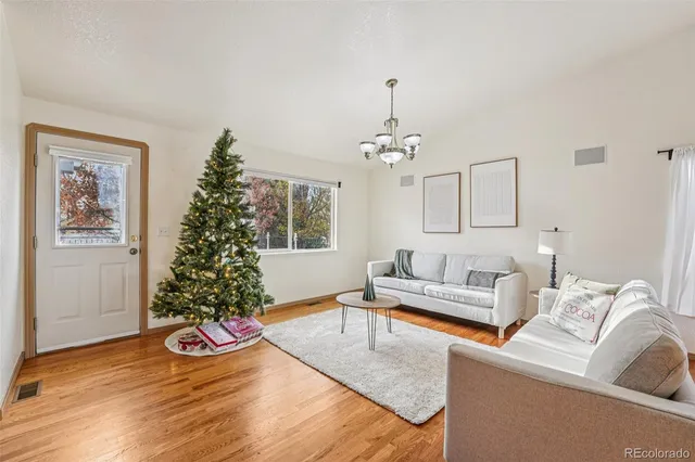 a living room with furniture and a chandelier