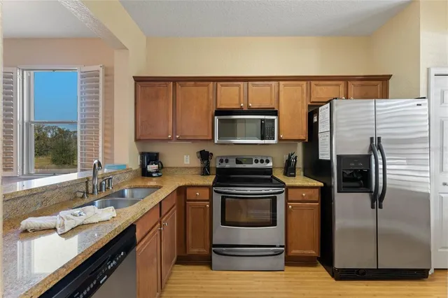 a kitchen with a sink stove and microwave