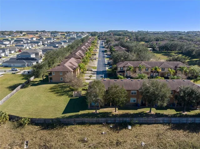 an aerial view of residential houses with outdoor space