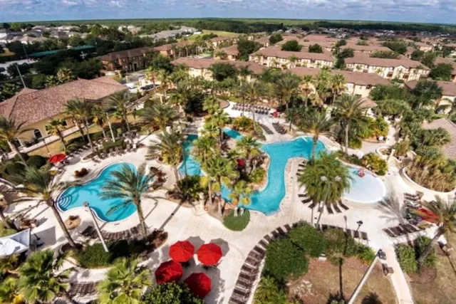 a dining area with stainless steel appliances lots of wooden furniture