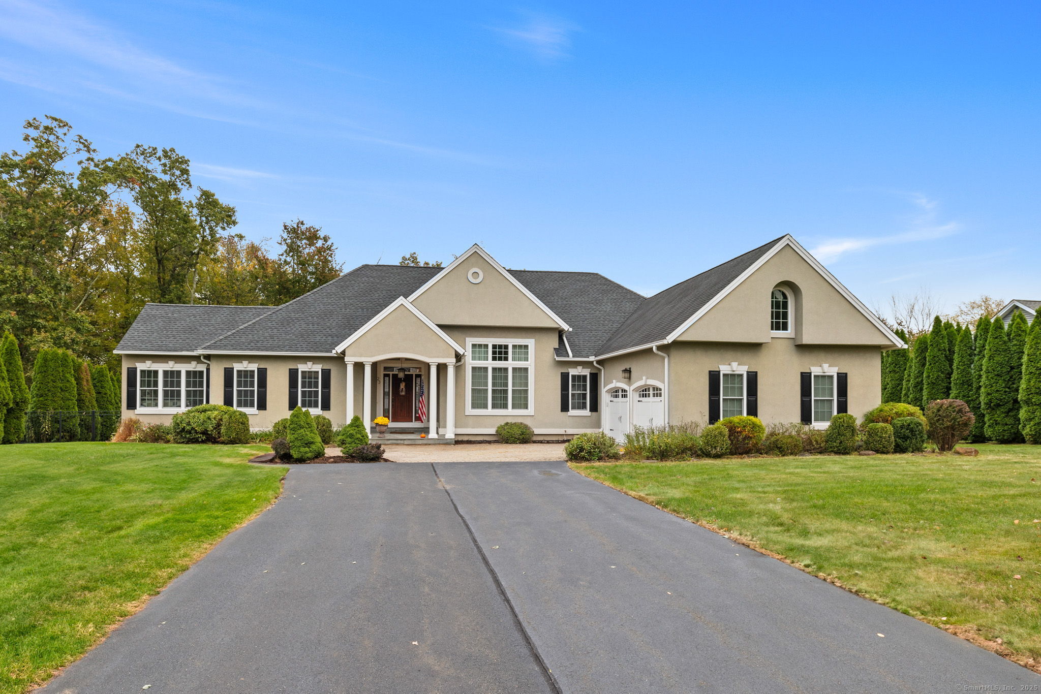 a front view of a house with yard and green space