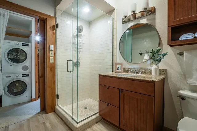 a bathroom with a toilet a sink and mirror