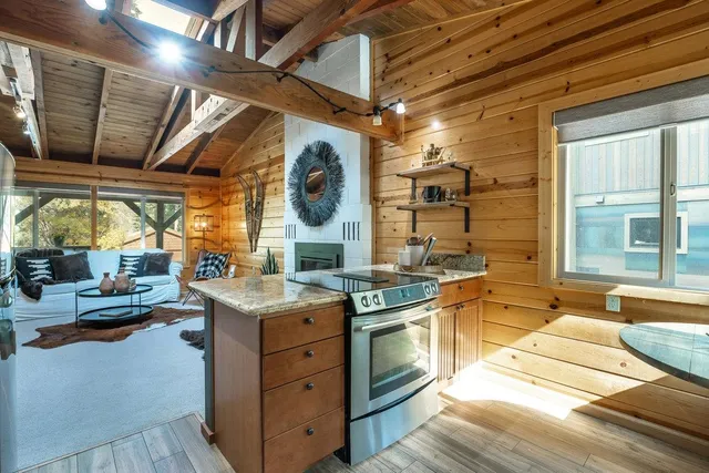 a kitchen with stainless steel appliances granite countertop a refrigerator and a stove top oven