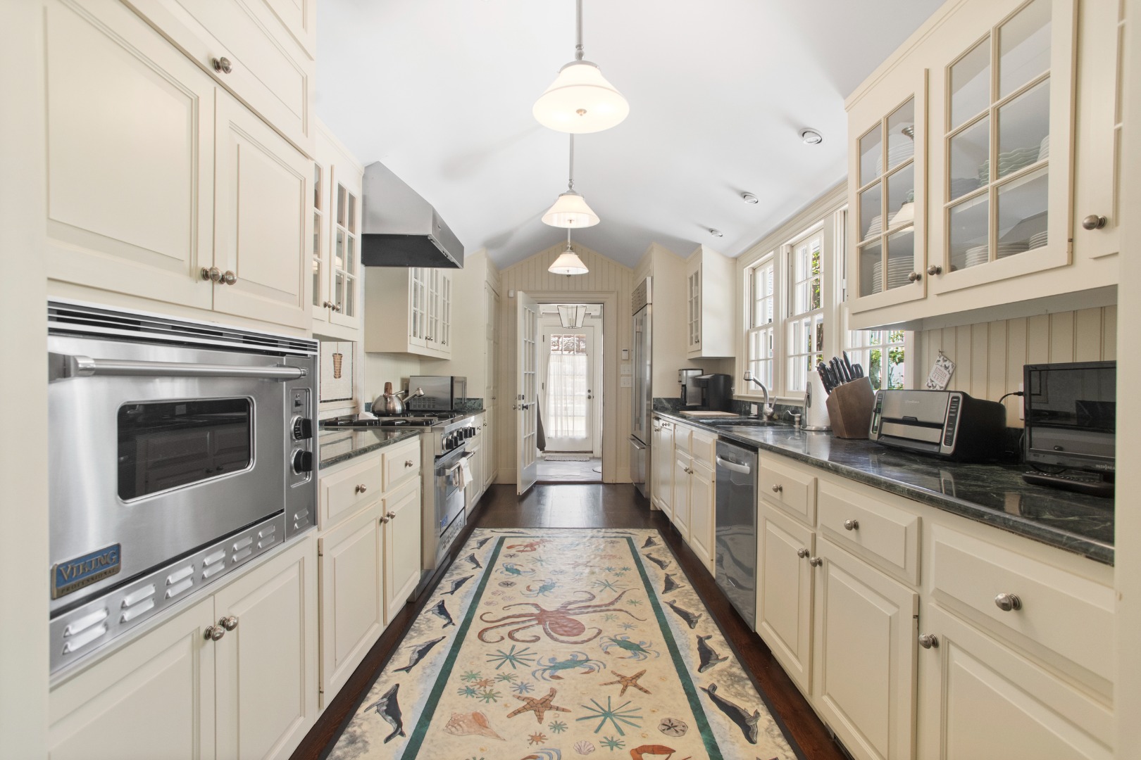 19 Orange Street Nantucket, MA 02554 - Photo 19 of 85 a large kitchen with stainless steel appliances granite countertop a stove a sink and a refrigerator