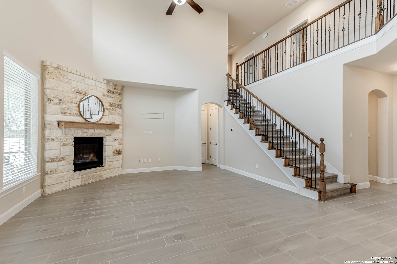 17419 Hillsedge Road San Antonio, TX 78257 - Photo 21 of 57 a view of an empty room with stairs and a fireplace