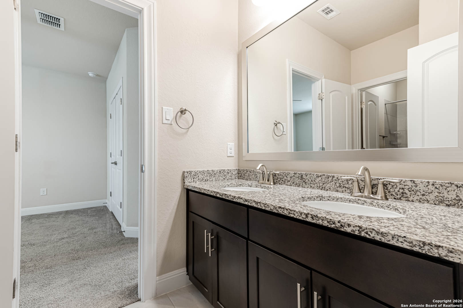 17419 Hillsedge Road San Antonio, TX 78257 - Photo 36 of 57 a bathroom with a granite countertop sink and a mirror