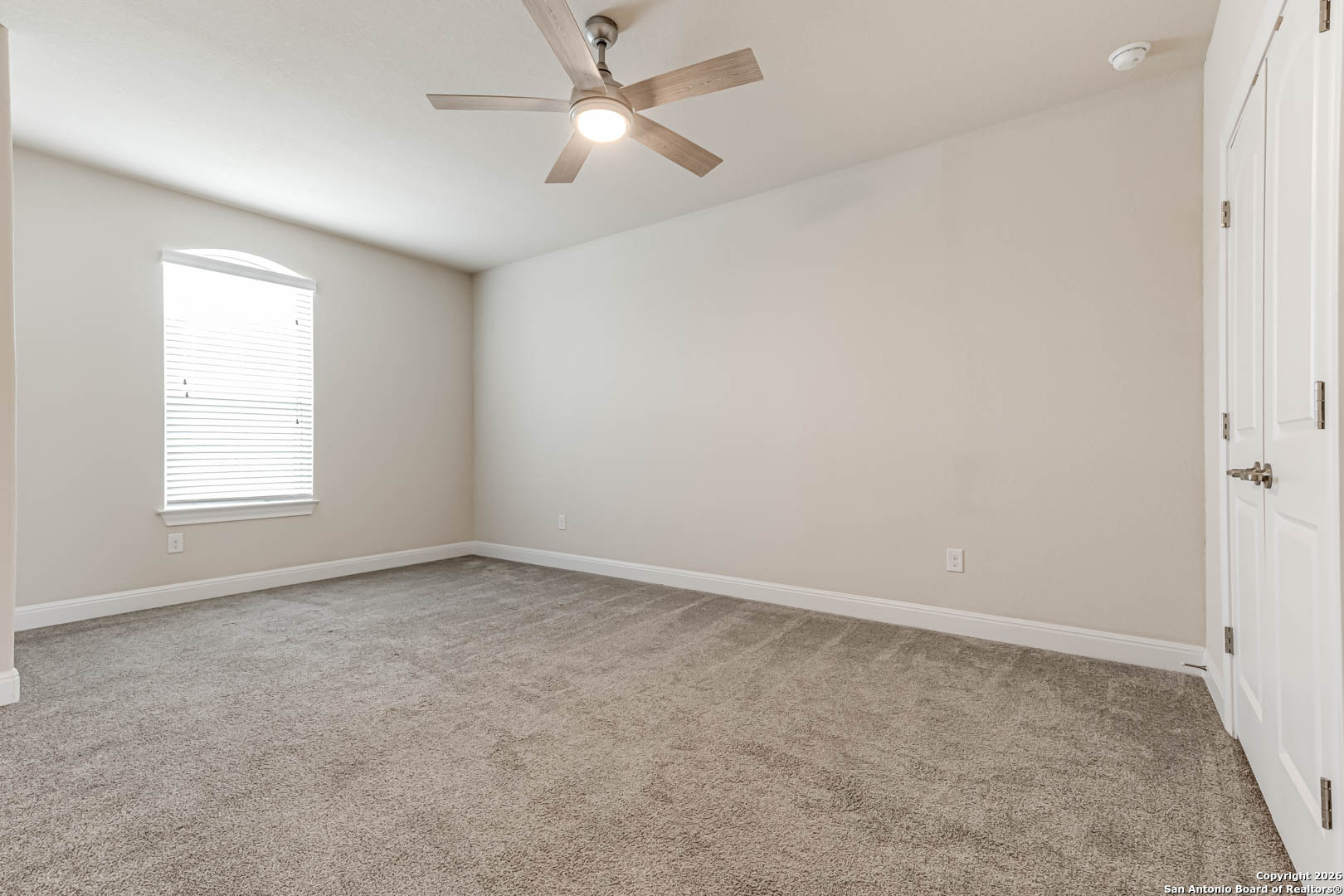 17419 Hillsedge Road San Antonio, TX 78257 - Photo 38 of 57 an empty room with a window and a fan